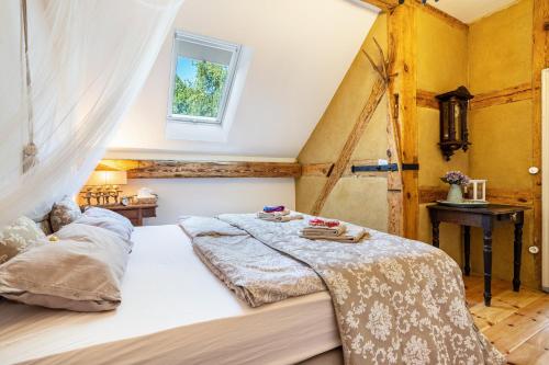 a bedroom with a large bed in a attic at Ferienwohnung im Landschloss in Calau
