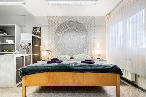 a bedroom with a large bed with purple pillows on it at Wohncontainer Derdak in Boizenburg