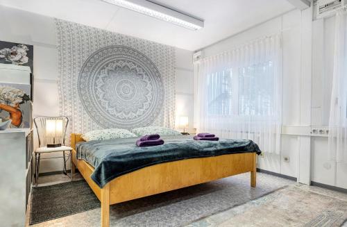 a bedroom with a bed with purple towels on it at Wohncontainer Derdak in Boizenburg