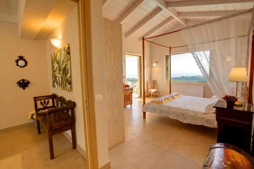a bedroom with a bed and a large window at Villa Corali Ideales Resort in Kefallonia