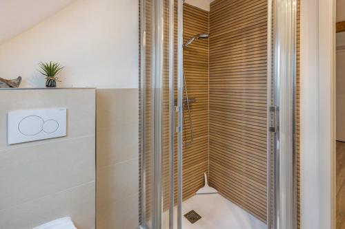a shower with wooden blinds in a bathroom at Ferienwohnung Degen in Donaueschingen