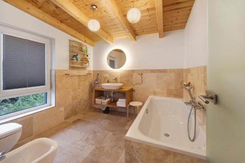 a bathroom with a tub and a sink at Ferienhaus mit Panoramablick in Gernrode