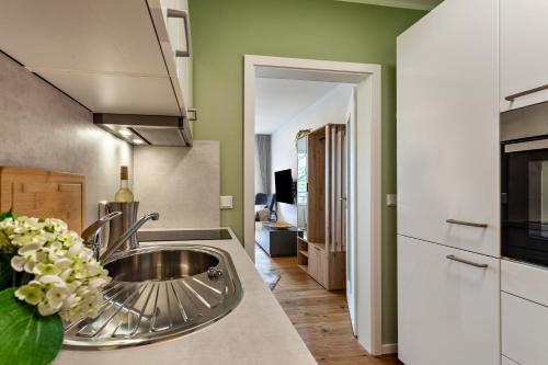 a kitchen with a stainless steel sink in a kitchen at Berg und Tal Apartment in Brilon