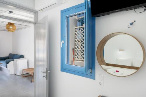a mirror and a blue cabinet in a living room at Nicolas House 4 in Rakhídhion