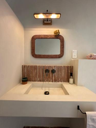 a bathroom with a sink and a mirror at Chambres d'hote Bergerie A Maredda in Murato