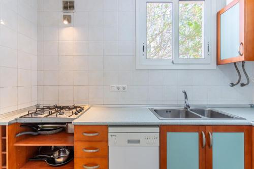 a kitchen with a sink and a stove at Casa Yves in Tossa de Mar