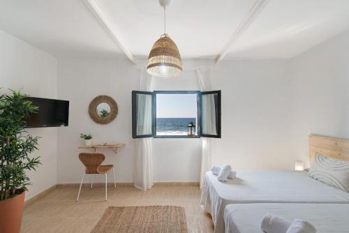 a bedroom with a bed and a view of the ocean at El Altillo House in Moya