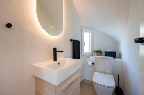 a white bathroom with a sink and a toilet at Rocas del Mar in Mijas