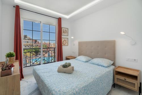 a bedroom with a bed and a large window at Granada Park S01A in Arona