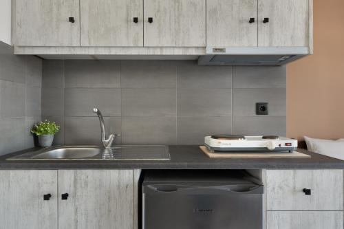a kitchen counter with a sink and a stove at Frantzis Studio 2 - Nisyros in Páloi