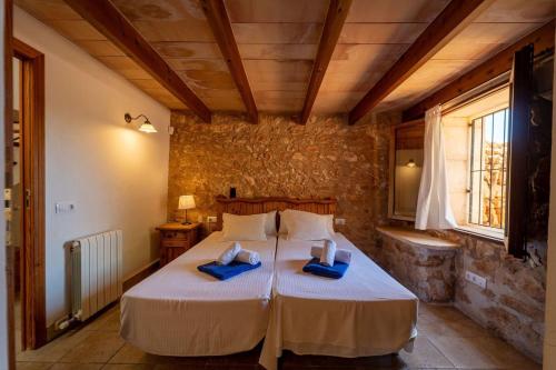 a bedroom with two beds with blue towels on them at Cugulutx in Llucmajor