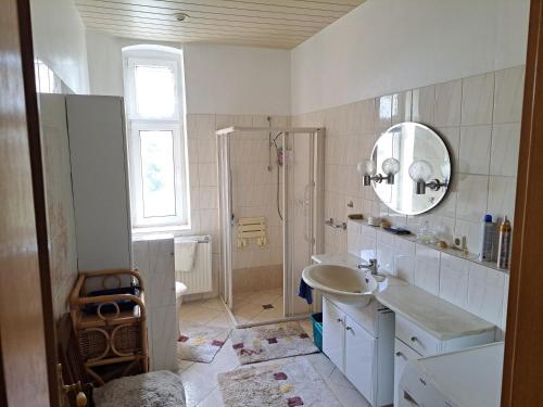 a white bathroom with a sink and a mirror at Hof Schumacher in Gumtow
