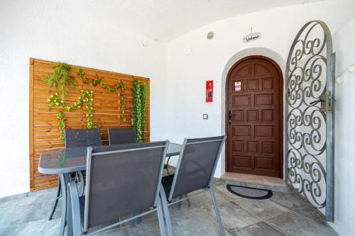 a dining room with a table and a wooden door at Palmera in Miami Platja