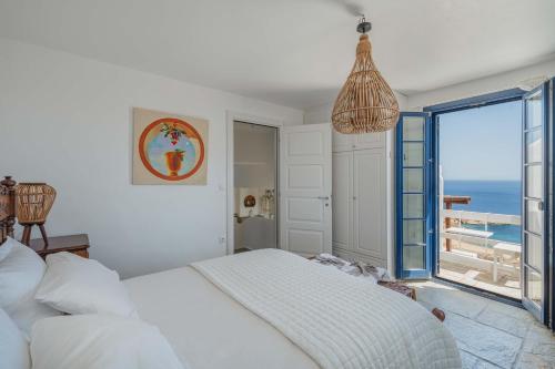 a bedroom with a bed and a view of the ocean at Villa Agios Sostis in Serifos Chora