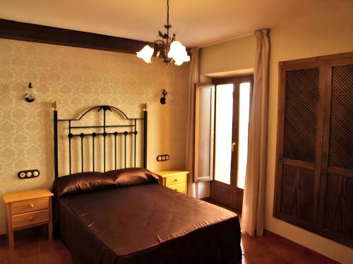 a bedroom with a large bed and a window at Can Joan in Rosell