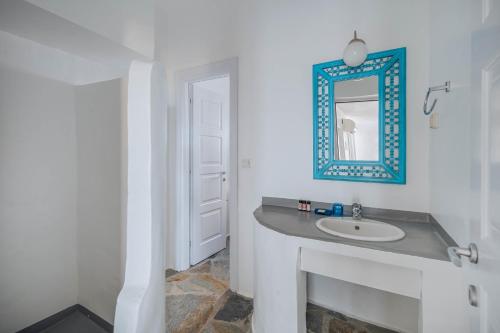 a bathroom with a sink and a mirror at Villa Agios Sostis in Serifos Chora