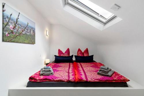 a bedroom with a king sized bed with red comforter at Zum Hobelmann in Endingen