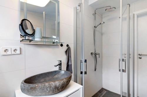 a bathroom with a stone sink and a shower at Zum Hobelmann in Endingen