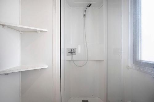 a shower in a white bathroom with a toilet at Bungalow T3 I I -15 Min From Nazaré in Pataias