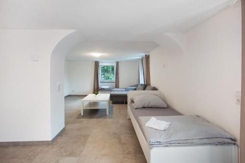 a room with a bed and a couch and a table at Ferienapartments Ariana in Bad Säckingen