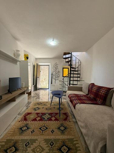a living room with a couch and a table at Casa Mark in Forza dʼAgro