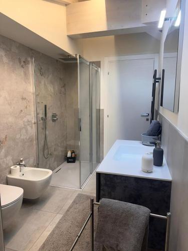 a bathroom with a shower and a sink and a toilet at La dolce vita - Lake Iseo in Paratico