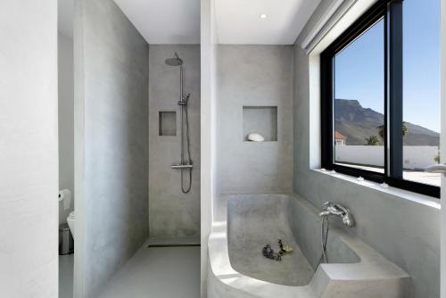 a bathroom with a bath tub and a window at Alba House in Adeje