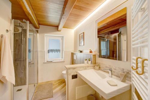 a bathroom with a sink and a shower at Appartamenti Cucu - 1 in Lillianes