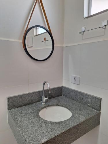a bathroom with a sink and a mirror at Modelo Prime Hotel in Ribas do Rio Pardo