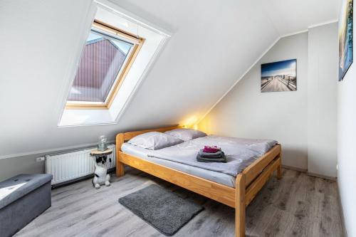 a small bedroom with a bed in a attic at Ferienwohnung Kiebitznest in Kaiser Wilhelm Koog