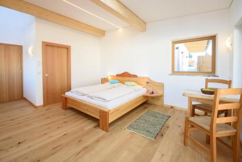 a bedroom with a bed and a table and a chair at Peter Paul Studio Gantkofl in Appiano sulla Strada del Vino