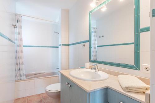 a bathroom with a sink and a toilet and a mirror at Veleta ll in Pollença