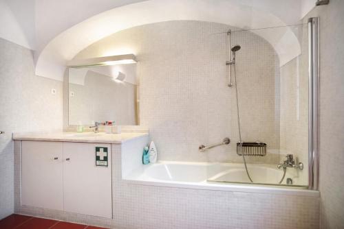 a bathroom with a tub and a sink and a shower at São Martinho All The Best in São Martinho do Porto