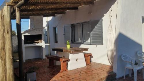 a patio with a table and a bench on a building at Conaguademar in La Paloma