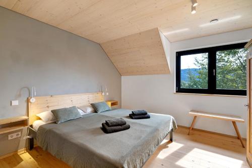 a bedroom with a large bed with two towels on it at Ferienappartements Bayer in Sigmarszell