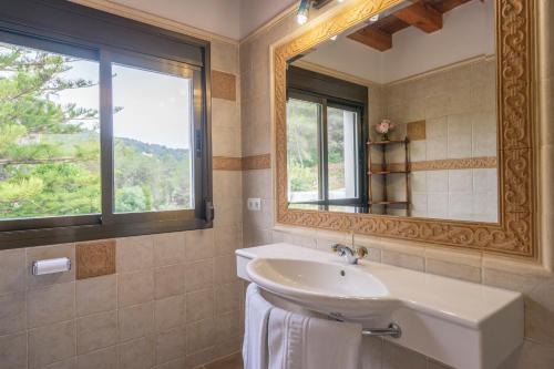 a bathroom with a sink and a mirror at Can Joan Vich I in Santa Eularia des Riu