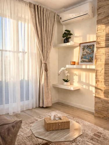 a living room with a large window and a table at DG - Urban Stay in Floreşti