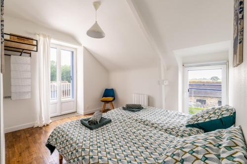 a bedroom with a bed and a large window at La maison des chevaux in Saint-Vran