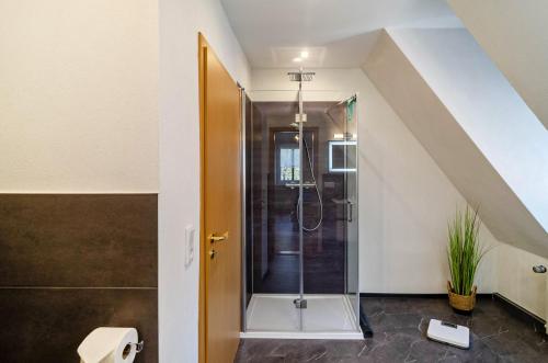 a bathroom with a shower in the attic at Ferienhaus am Park in Heudeber