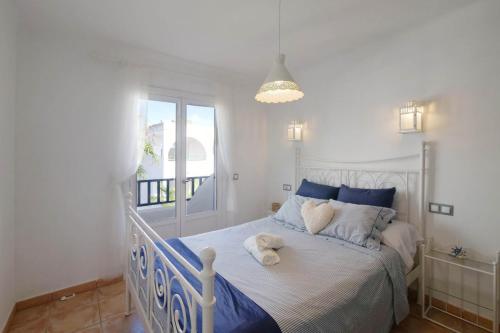 a bedroom with a bed with a teddy bear on it at Posidonia in Portocolom