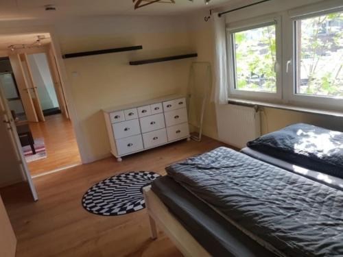 a bedroom with a bed and a dresser and window at Haus Mara in Emden