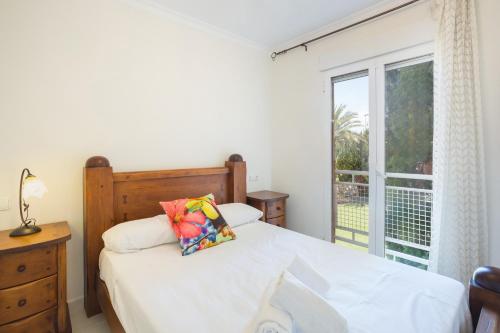a bedroom with a bed and a large window at Keops in Oliva