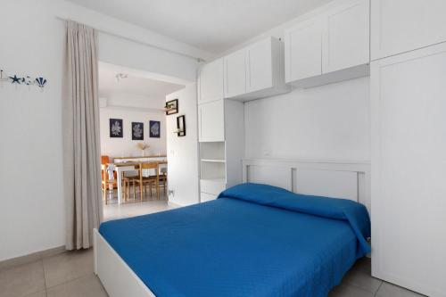 a bedroom with a blue bed and a dining room at Montemare in Ameglia