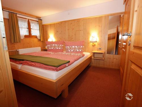 a bedroom with a large bed in a room at Erlenhof in Todtnau