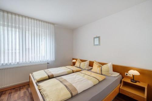 a bedroom with two beds and a window at Haus Am Weinberg 2 in Endingen
