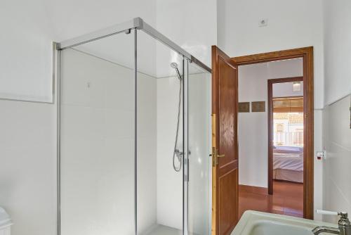 a bathroom with a shower and a glass door at Vtar Casa Palacio Vida in Espejo