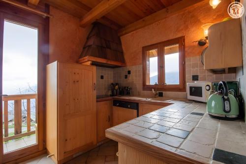 a kitchen with wooden cabinets and a counter top at La Gelinotte - Jarrier in Jarrier