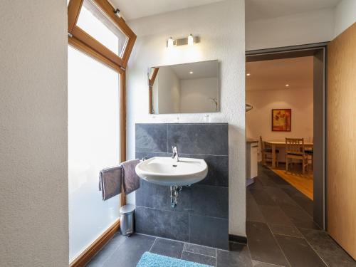 a bathroom with a sink and a mirror at Ferienwohnung Kobl in Immenstaad am Bodensee