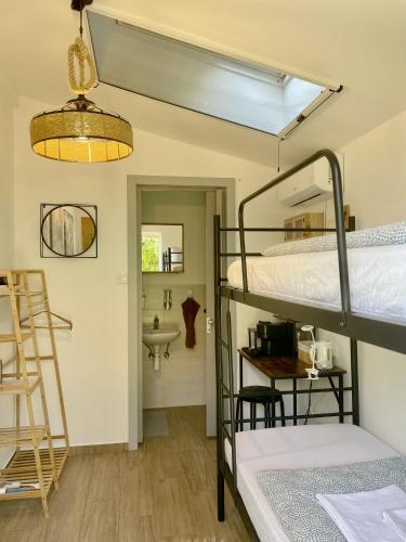 a room with two bunk beds and a sink at Cozy little hideaway in Balatonfüred