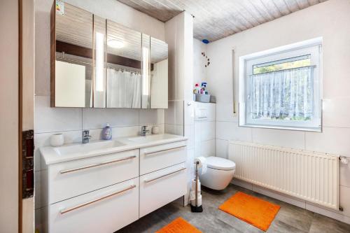 a white bathroom with a sink and a toilet at Ferienwohnung Fly in Wehr